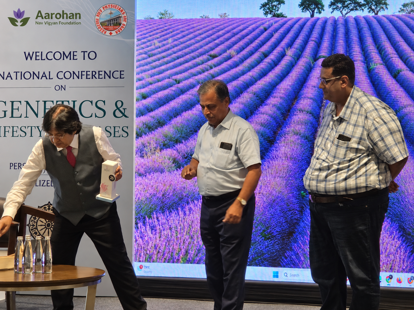 A memento being presented on stage at the National Conference on Genetics & Lifestyle Diseases